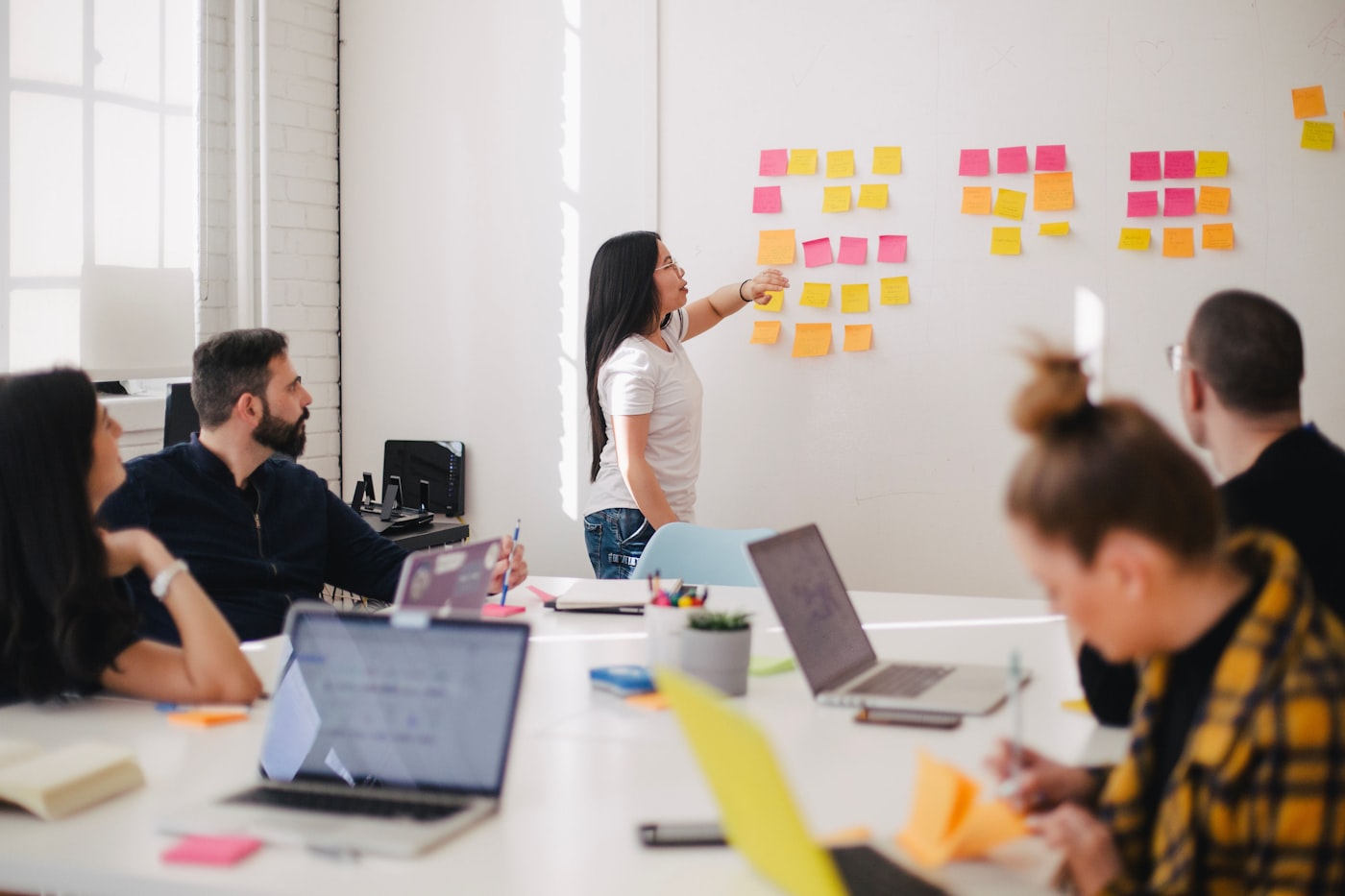 Business team reviewing a workflow strategy on a laptop
