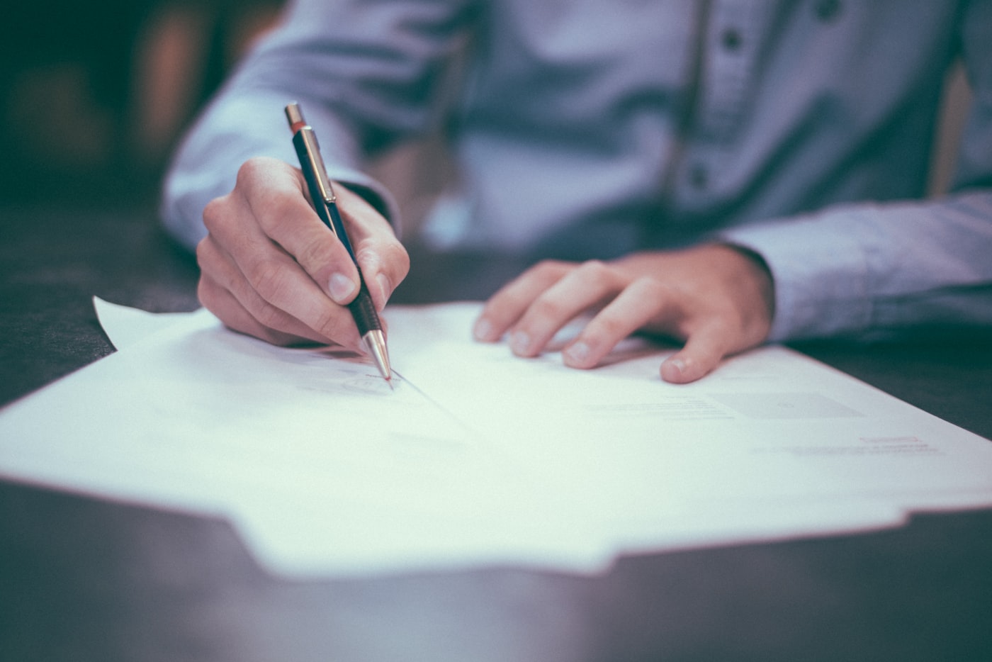 Compliance documents and laptop on a business desk