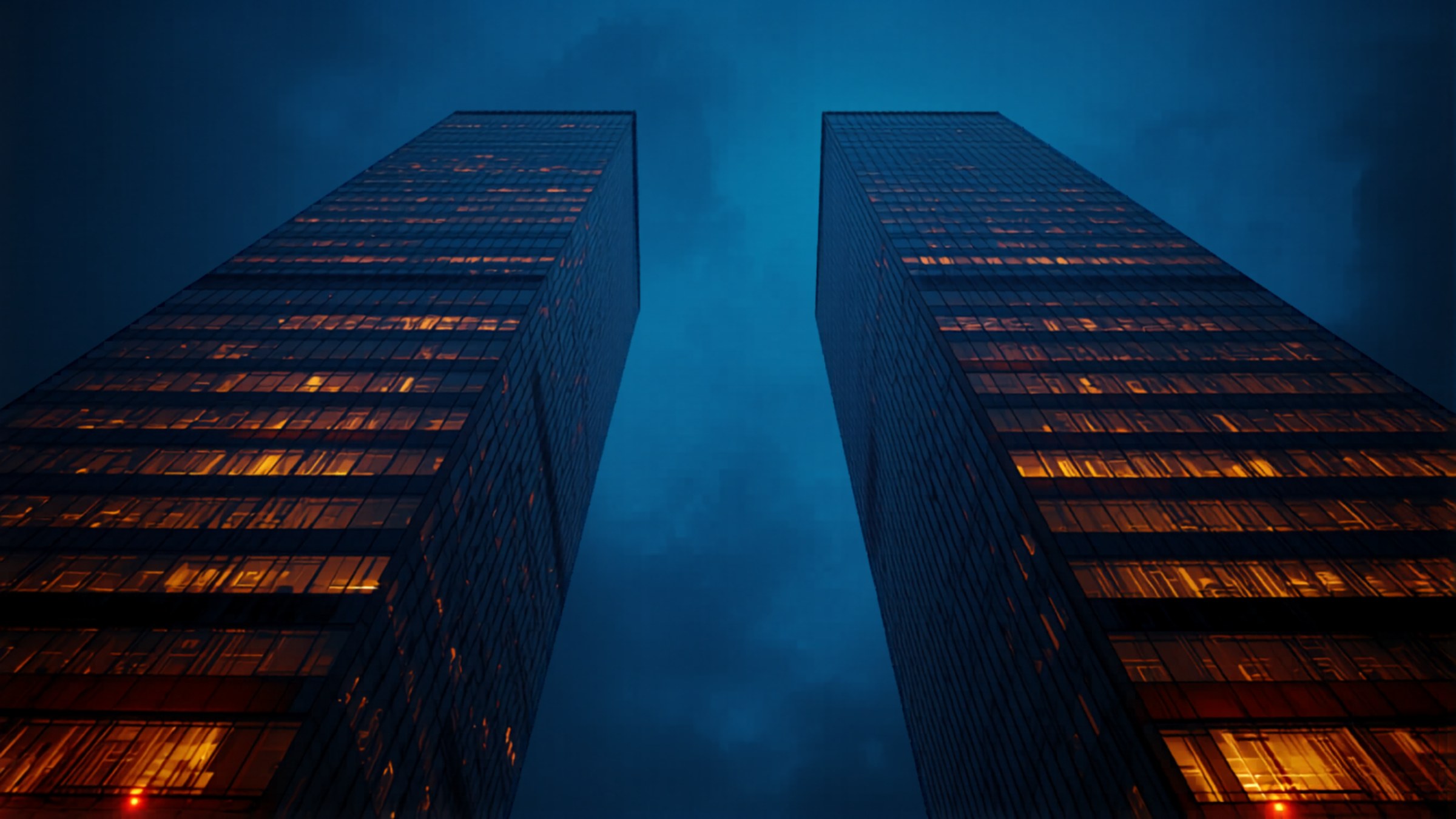 Modern financial district glass towers illuminated at dusk